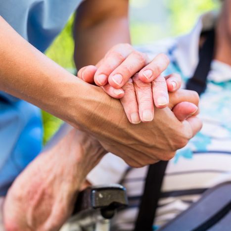 nurse and patient holding hands