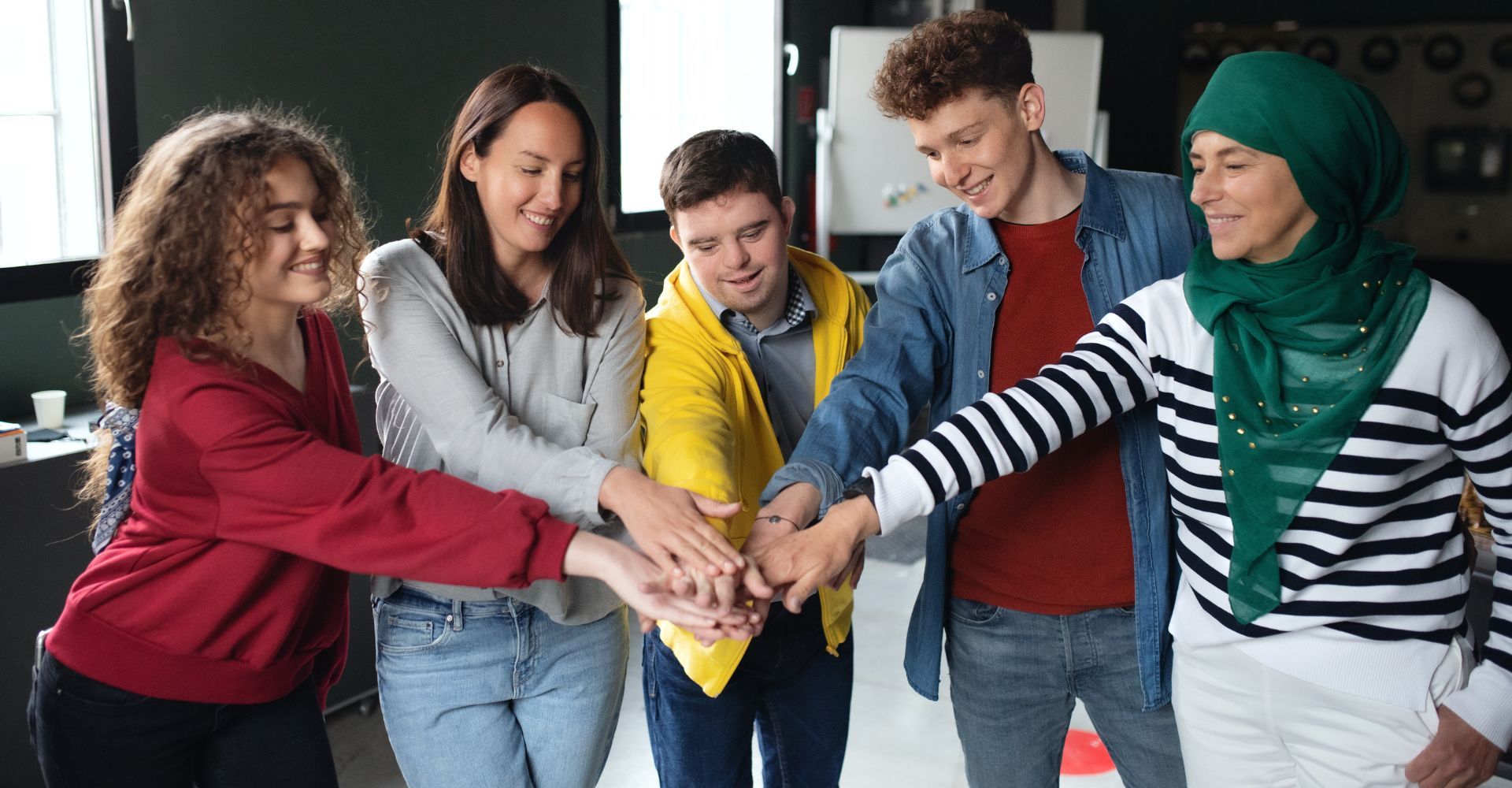 A group of friends in a team huddle