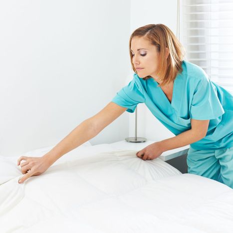 caregiver making a bed