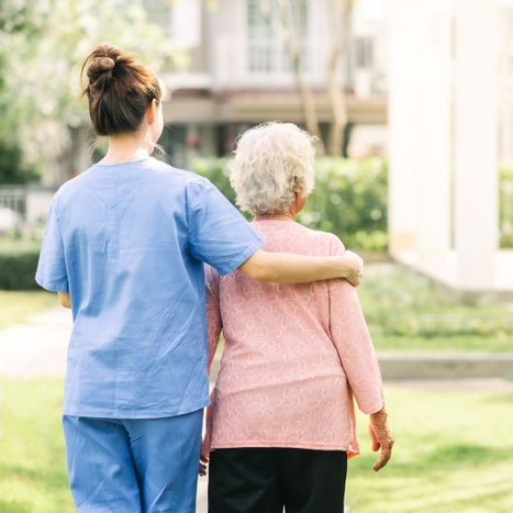 caregiver walking with special needs adult